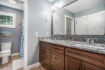 Freshen Up After a Day by the Shore in the Luxuries of the Second Level Guest Bathroom